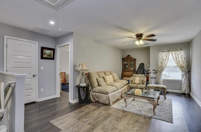 living room with dark hardwood / wood-style flooring and ceiling fan