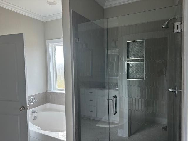 bathroom featuring crown molding and independent shower and bath