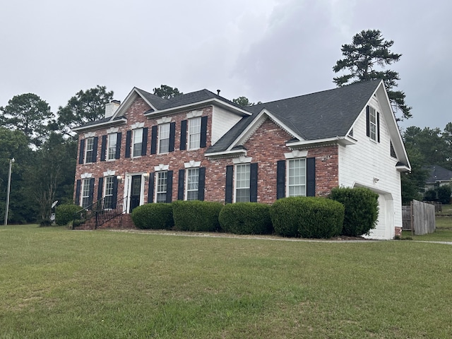 2102 Howard Mill Rd, North Augusta, SC 29841 - view of front of home with brick siding, a front yard, a chimney, and a shingled roof