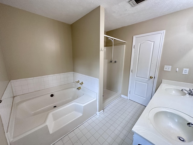 2102 Howard Mill Rd, North Augusta, SC 29841 - full bathroom with a bath, tile patterned flooring, double vanity, a shower stall, and a textured ceiling