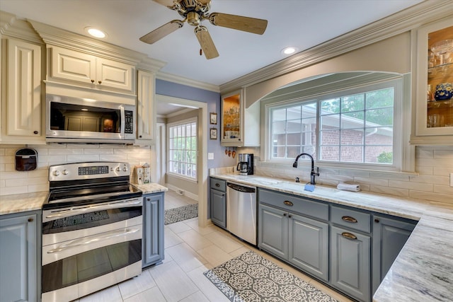 711 Augusta St, Mccormick, SC 29835 - kitchen with stainless steel appliances, gray cabinetry, glass insert cabinets, tasteful backsplash, and light stone counters