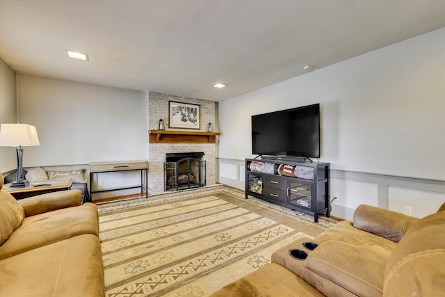 711 Augusta St, Mccormick, SC 29835 - living area featuring a brick fireplace, a decorative wall, a wainscoted wall, and recessed lighting