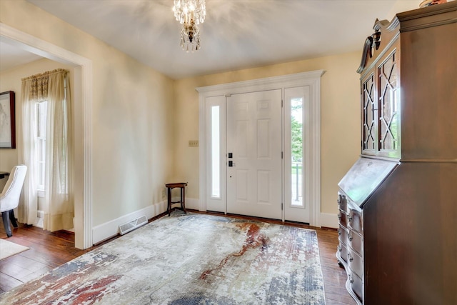 711 Augusta St, Mccormick, SC 29835 - entryway featuring hardwood / wood-style flooring, baseboards, and a chandelier