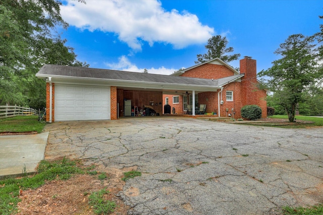 711 Augusta St, Mccormick, SC 29835 - view of side of home featuring an attached garage, brick siding, driveway, and a chimney