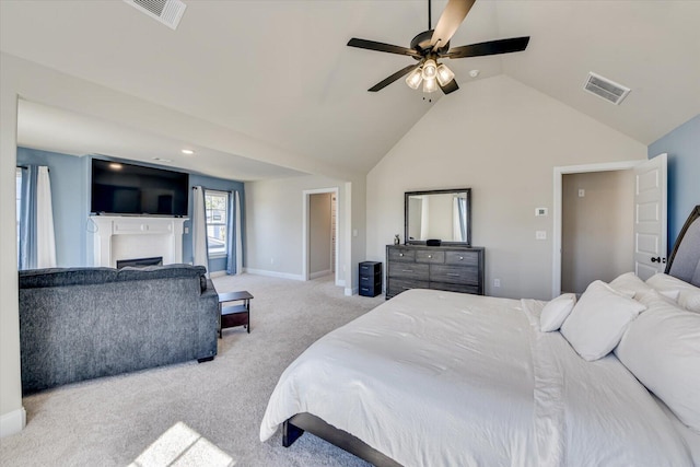 carpeted bedroom featuring lofted ceiling, a fireplace, visible vents, and baseboards