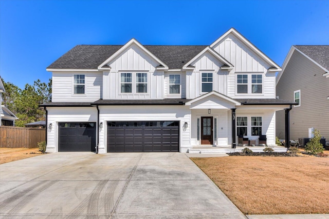 view of front of property with concrete driveway, an attached garage, central AC unit, board and batten siding, and fence