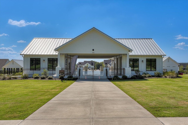 view of front of home with board and batten siding, covered porch, a front lawn, and concrete driveway