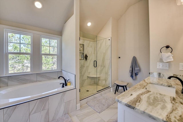 bathroom featuring lofted ceiling, marble finish floor, vanity, a shower stall, and a bath