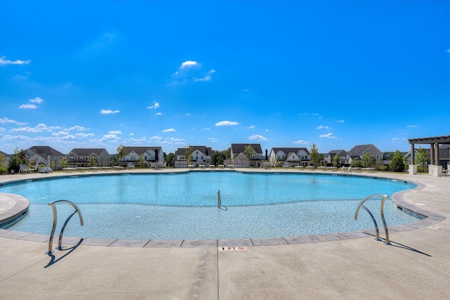 community pool featuring a patio, a residential view, and a pergola