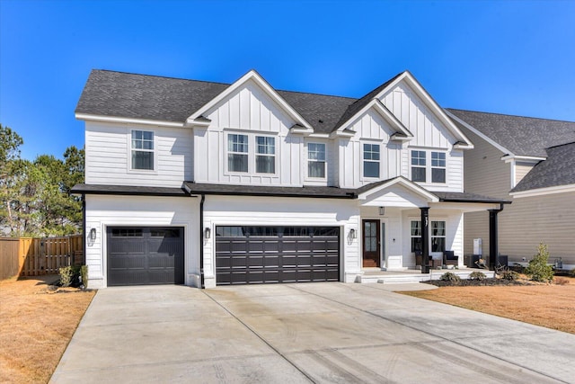 modern farmhouse featuring a garage, concrete driveway, fence, a porch, and board and batten siding