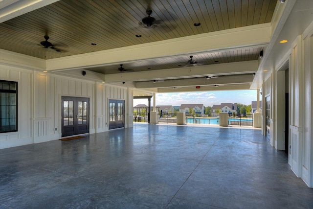 interior space with ceiling fan and french doors