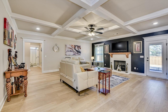 living area featuring coffered ceiling, beamed ceiling, and light wood-style flooring