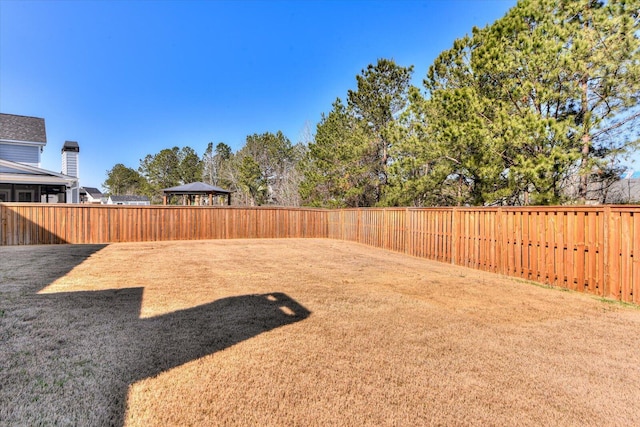 view of yard with a gazebo and a fenced backyard