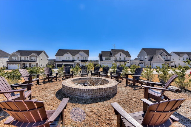 view of patio / terrace with a fire pit and a residential view