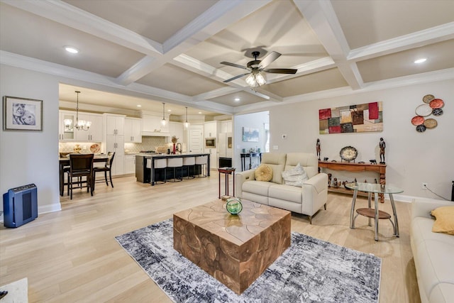 living area with ceiling fan with notable chandelier, beamed ceiling, coffered ceiling, and light wood-style flooring