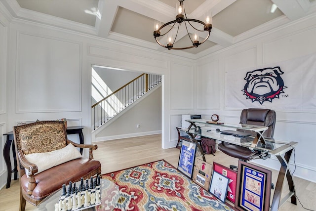 office area with crown molding, coffered ceiling, a decorative wall, and an inviting chandelier