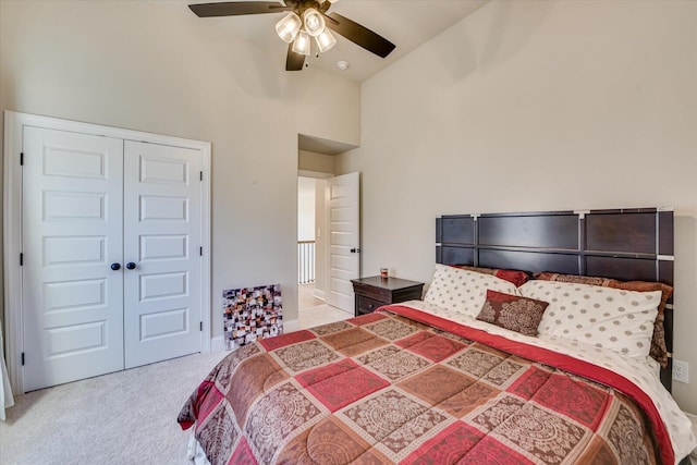 carpeted bedroom featuring ceiling fan, vaulted ceiling, and a closet