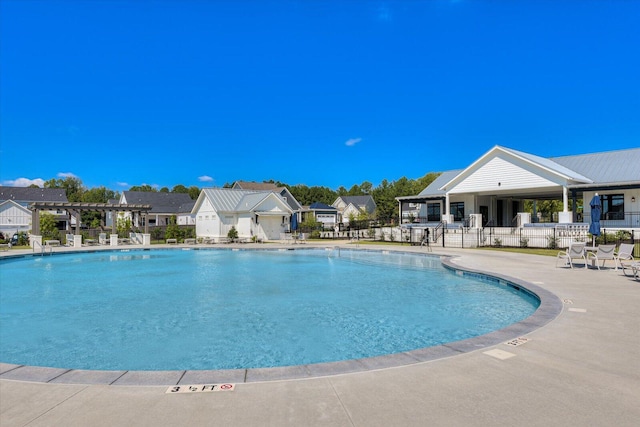 pool featuring a patio, fence, a residential view, and a pergola