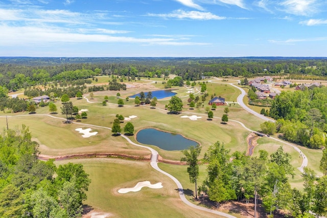 aerial view featuring a water view, a view of trees, and golf course view