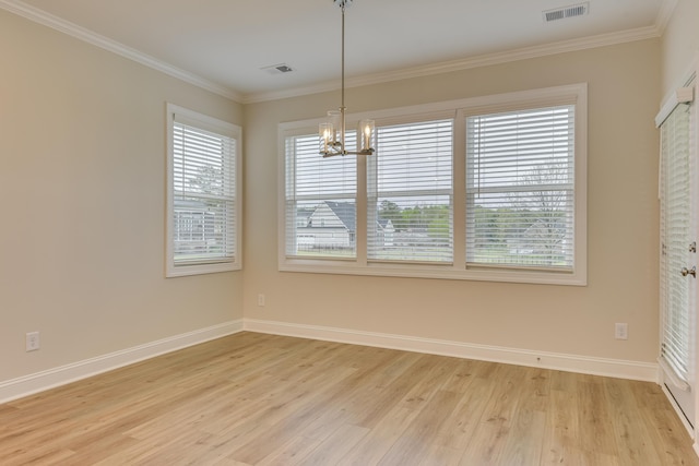 unfurnished dining area with light wood finished floors, visible vents, baseboards, ornamental molding, and a notable chandelier