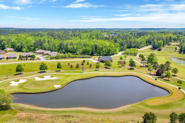 drone / aerial view with a forest view, a water view, and view of golf course