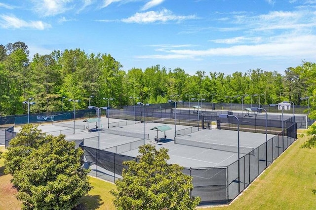 view of tennis court featuring fence