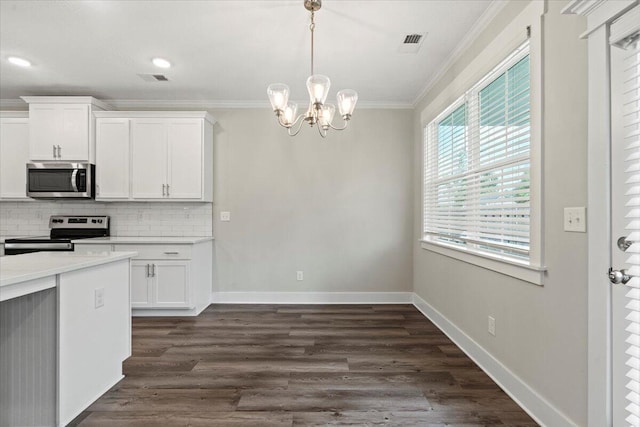 2318 Laurens St, Grovetown, GA 30813 - kitchen featuring stainless steel appliances, crown molding, decorative backsplash, white cabinetry, and a chandelier