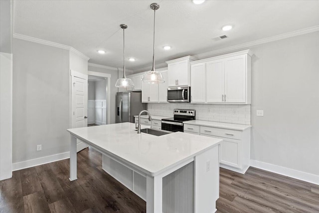2318 Laurens St, Grovetown, GA 30813 - kitchen with stainless steel appliances, a kitchen island with sink, ornamental molding, baseboards, and white cabinetry
