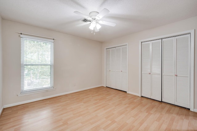 20 Teal Ct, North Augusta, SC 29841 - unfurnished bedroom with multiple closets, baseboards, and light wood finished floors