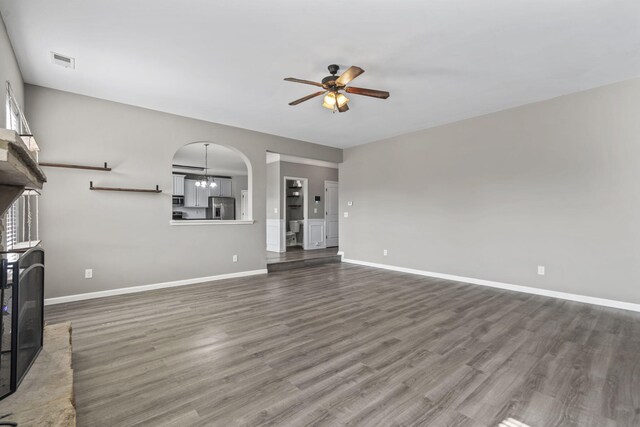 4938 Coal Creek Dr, Graniteville, SC 29829 - unfurnished living room with ceiling fan, wood finished floors, arched walkways, and baseboards