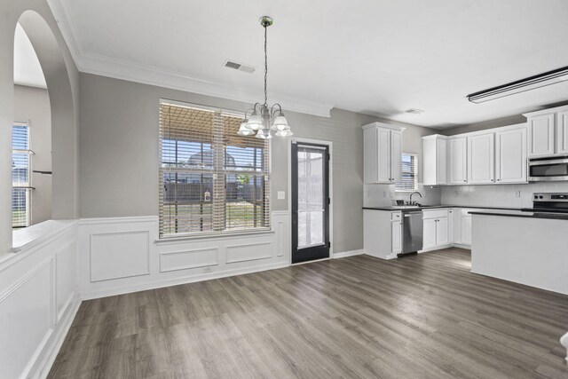 4938 Coal Creek Dr, Graniteville, SC 29829 - kitchen featuring stainless steel appliances, dark wood finished floors, a wainscoted wall, white cabinets, and a chandelier