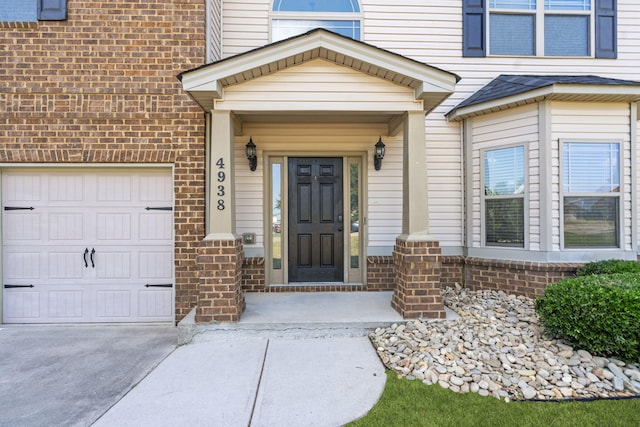 4938 Coal Creek Dr, Graniteville, SC 29829 - view of exterior entry with brick siding, a garage, and concrete driveway