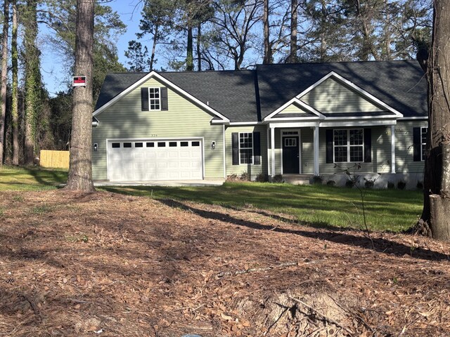 view of front facade featuring a porch and a garage