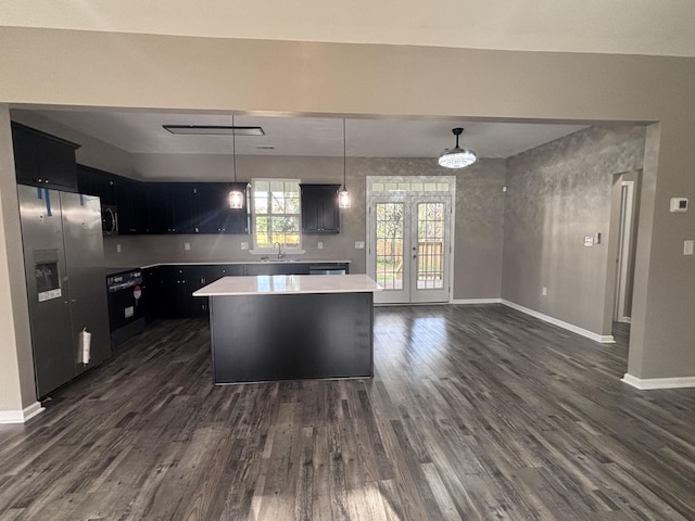 kitchen featuring dark wood-style flooring, a sink, light countertops, french doors, and stainless steel fridge