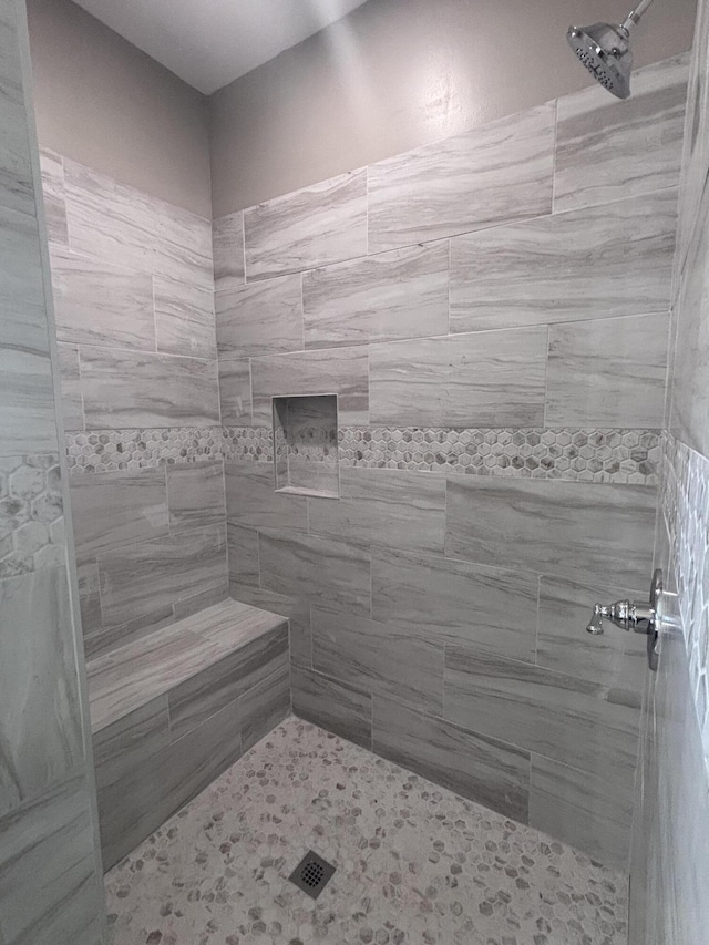 full bath with a tile shower