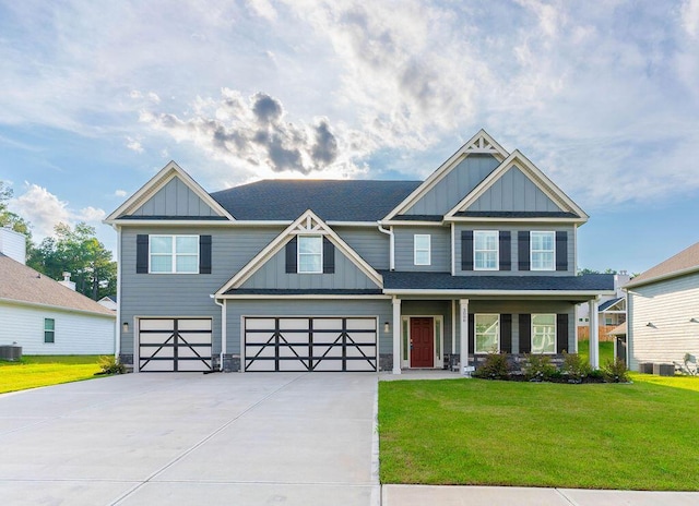 craftsman-style home with central AC, a garage, and a front lawn