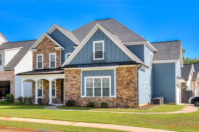 craftsman-style home featuring a front lawn and central air condition unit