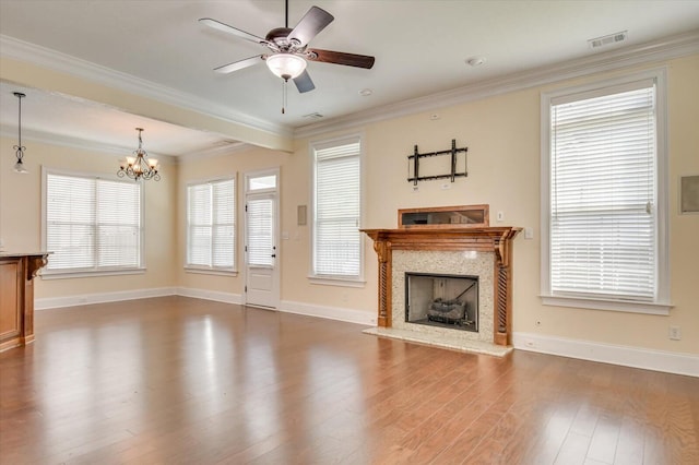 unfurnished living room featuring dark hardwood / wood-style flooring, ceiling fan with notable chandelier, and ornamental molding