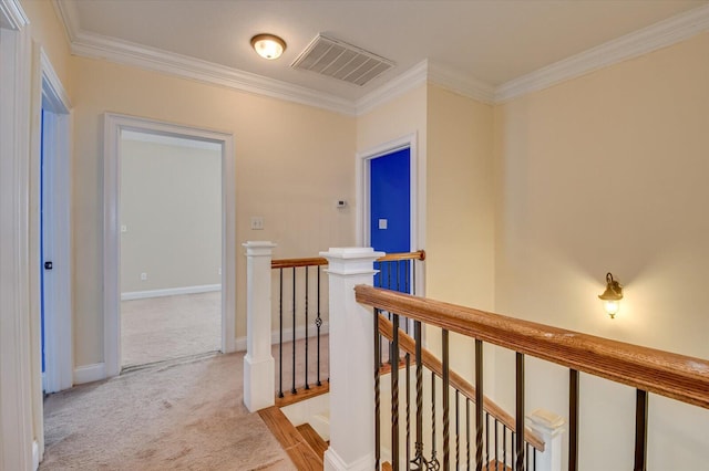 corridor with light colored carpet and ornamental molding