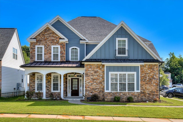 craftsman house with covered porch and a front yard