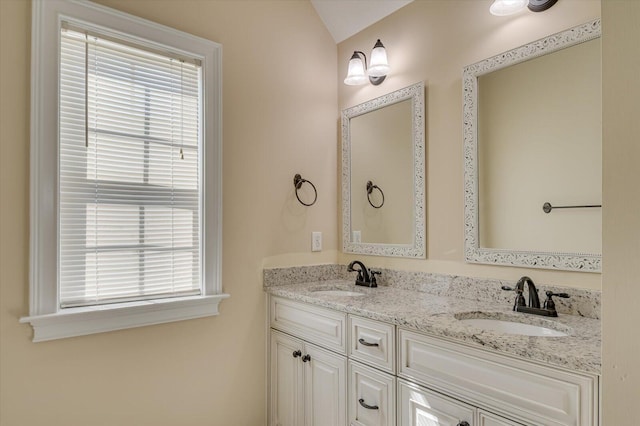 bathroom featuring vanity and vaulted ceiling