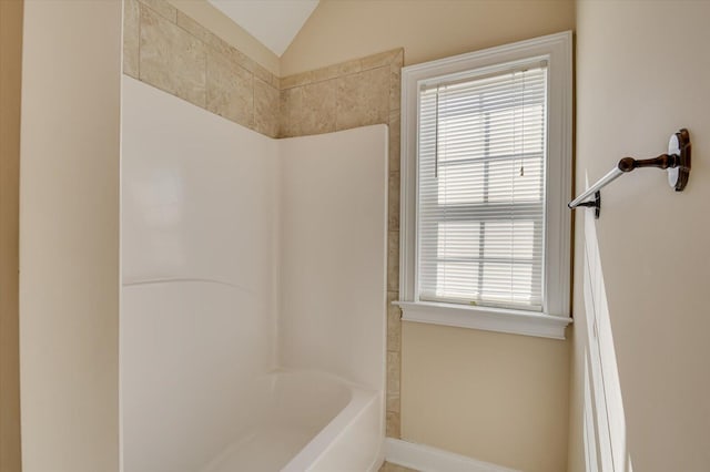 bathroom featuring shower / bathtub combination and vaulted ceiling