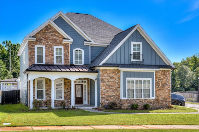 view of front of property featuring covered porch and a front yard