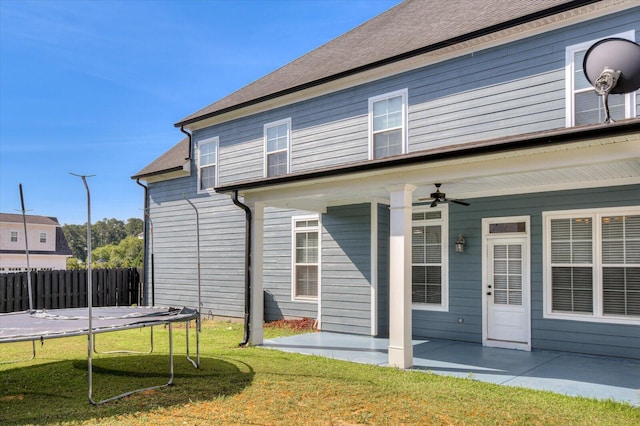 rear view of property with a patio, a trampoline, and ceiling fan