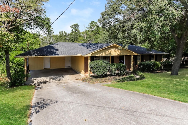 ranch-style house with a front yard and a carport