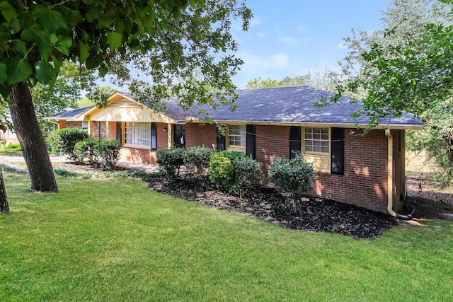 ranch-style home with a front lawn