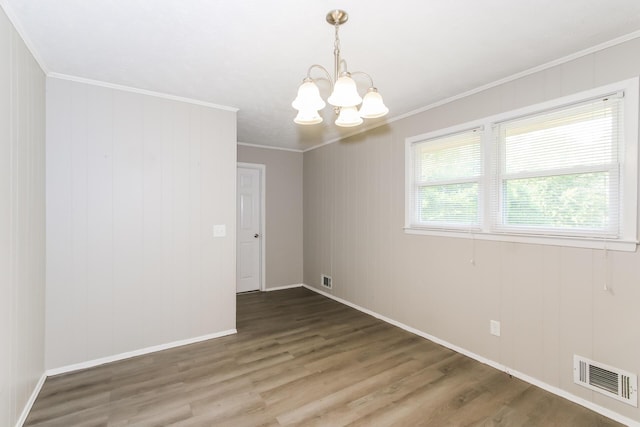 unfurnished room featuring ornamental molding, dark hardwood / wood-style floors, and a notable chandelier