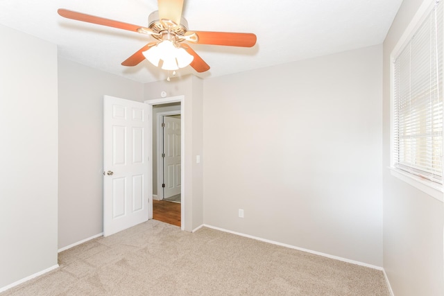 unfurnished bedroom featuring ceiling fan and light colored carpet