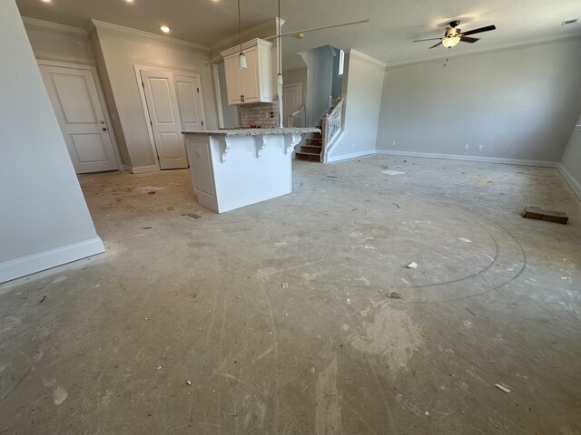 28 Coslett Dr, North Augusta, SC 29860 - kitchen featuring ornamental molding, a ceiling fan, a kitchen breakfast bar, white cabinets, and hanging light fixtures