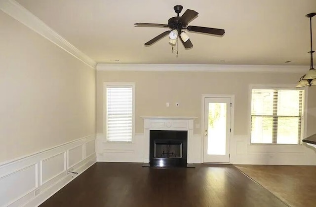 1139 Prides Xing, Aiken, SC 29801 - unfurnished living room featuring crown molding, wainscoting, plenty of natural light, a fireplace, and a decorative wall